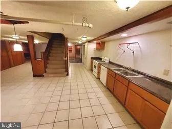 a kitchen with stainless steel appliances kitchen island granite countertop a refrigerator and a stove