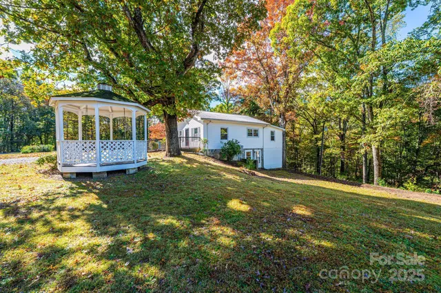 a front view of a house with a yard and trees