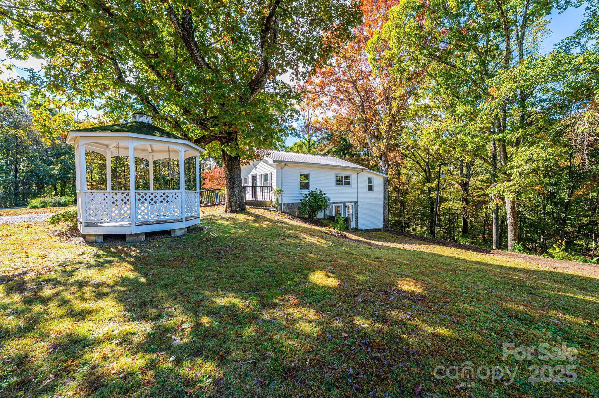 a front view of a house with a yard and trees