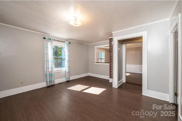 a large room with a window and a chandelier