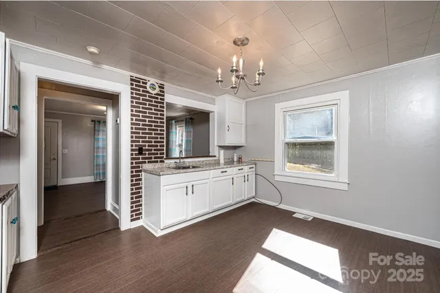 a spacious bathroom with a granite countertop sink mirror and view