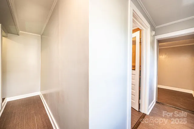 an empty room with wooden floor and door