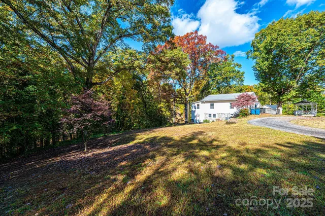 a yellow house with trees in front of it