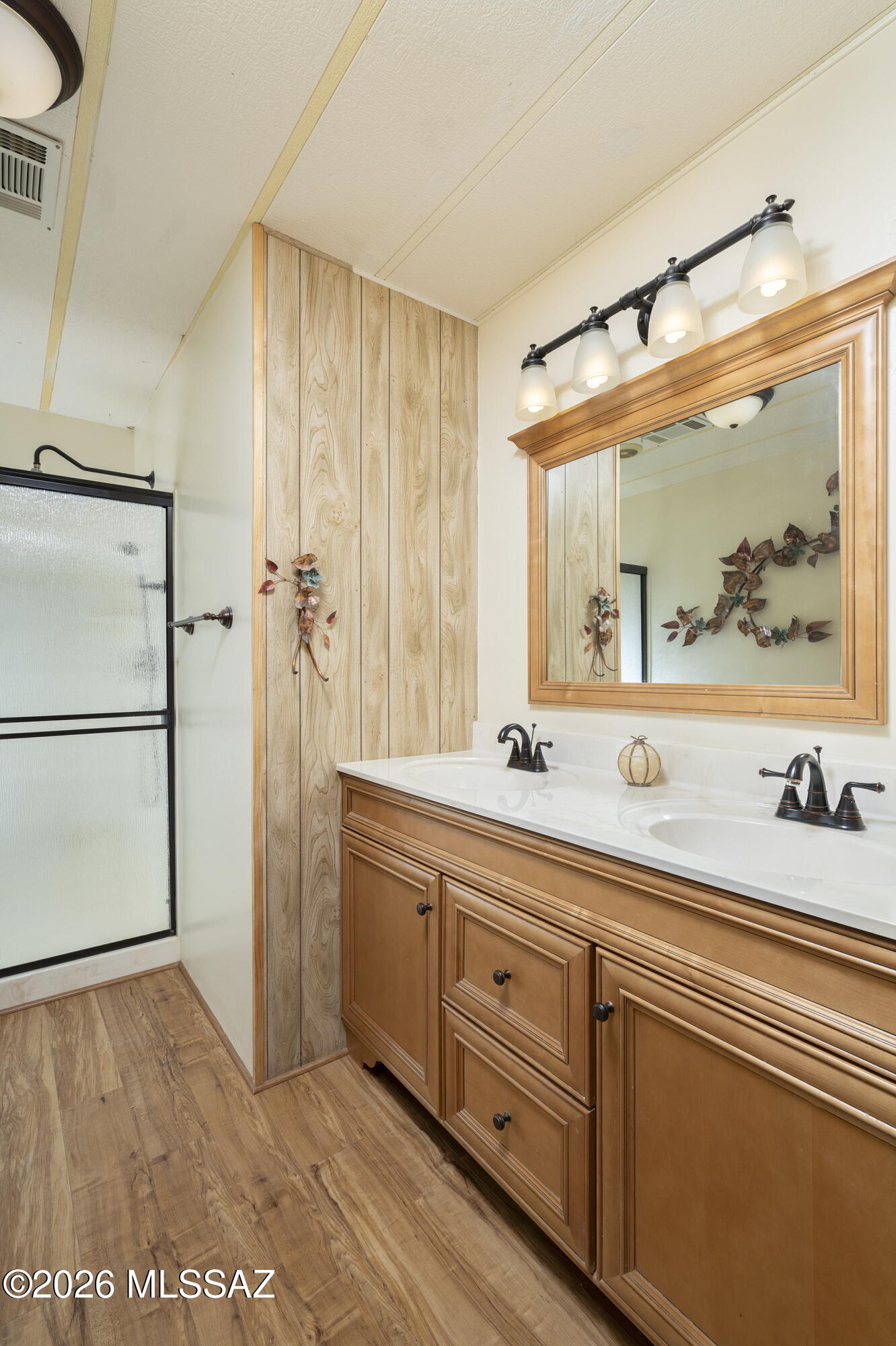 6121 West Flying M Street Tucson, AZ 85713 - Photo 13 of 25 a spacious bathroom with a double vanity sink and a mirror