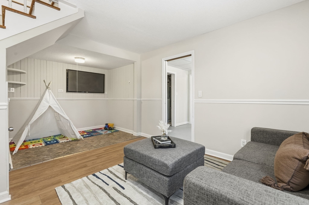 500 Franklin Street Wrentham, MA 02093 - Photo 26 of 34 a living room with a couch and a flat screen tv