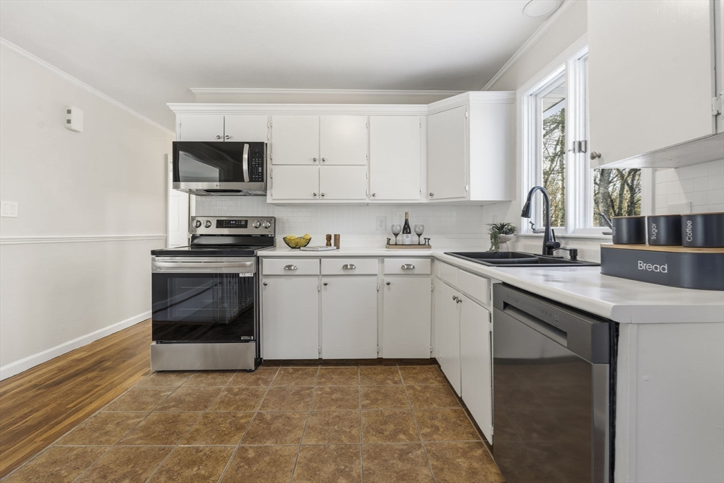 500 Franklin Street Wrentham, MA 02093 - Photo 6 of 34 a kitchen with stainless steel appliances a stove a sink a microwave and cabinets