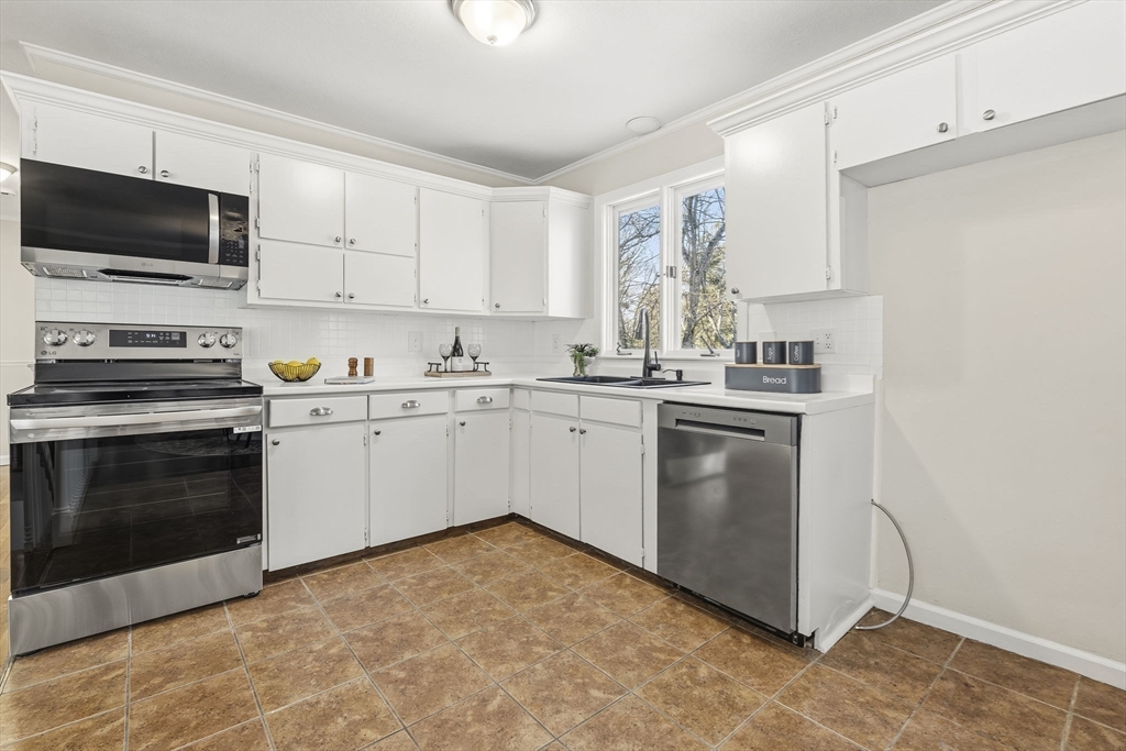 500 Franklin Street Wrentham, MA 02093 - Photo 7 of 34 a kitchen with a sink stove and microwave