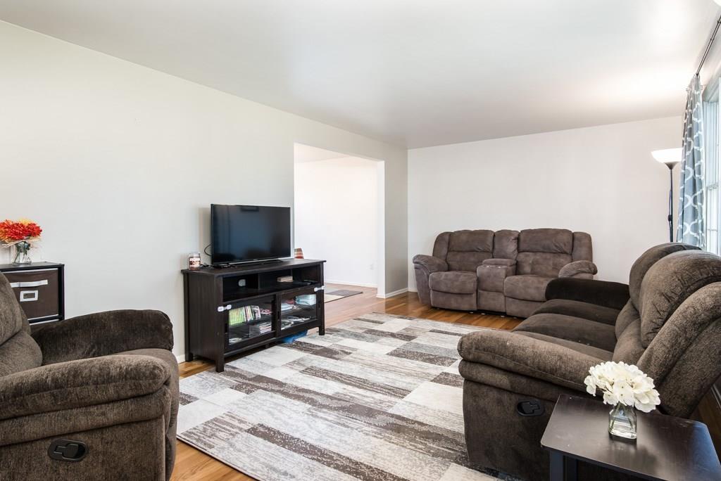 128 Herbst Road Coraopolis, PA 15108 - Photo 3 of 24 a living room with furniture and a flat screen tv