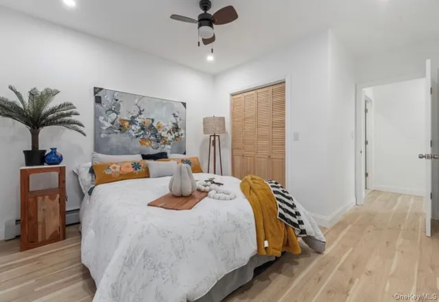 a bedroom with a large bed and a chandelier