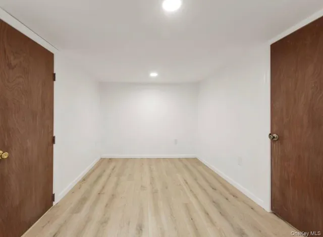 a view of room with wooden floor
