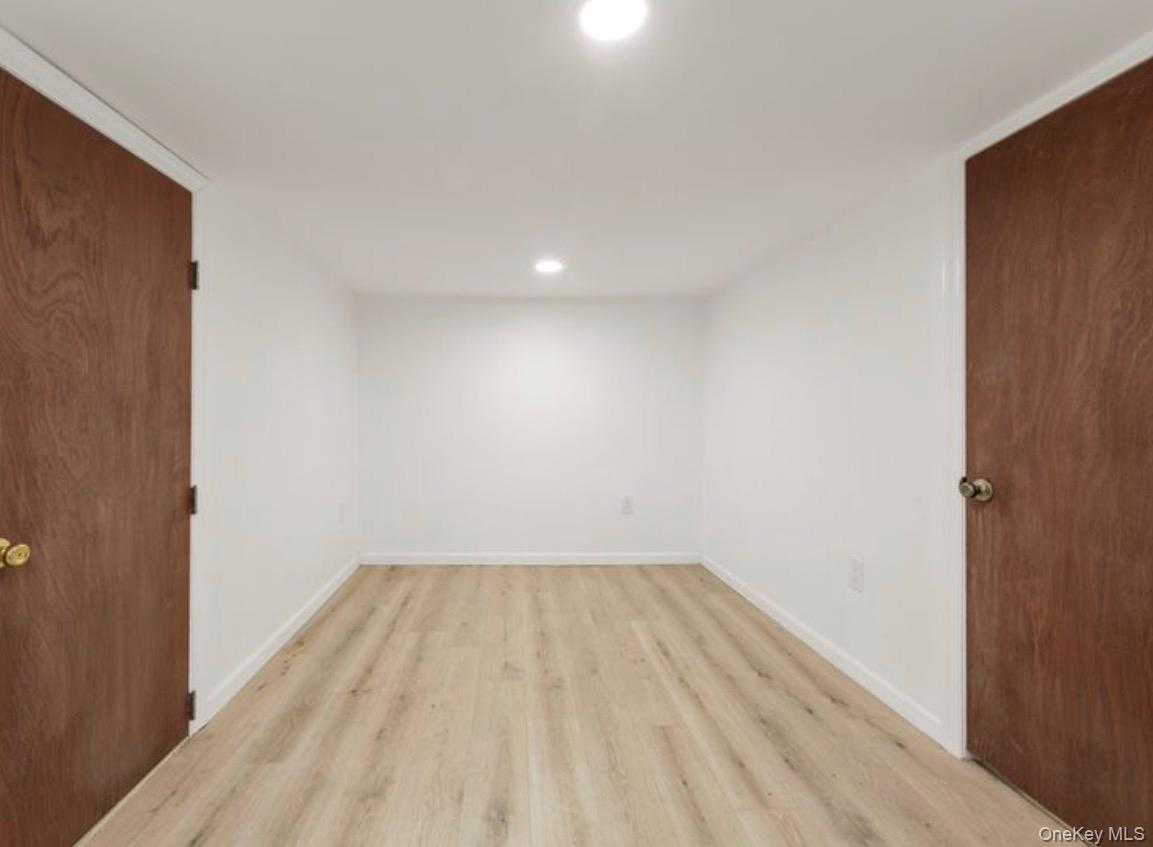 136-18 221st Street Queens, NY 11413 - Photo 17 of 23 Unfurnished bedroom with recessed lighting and light wood-style flooring