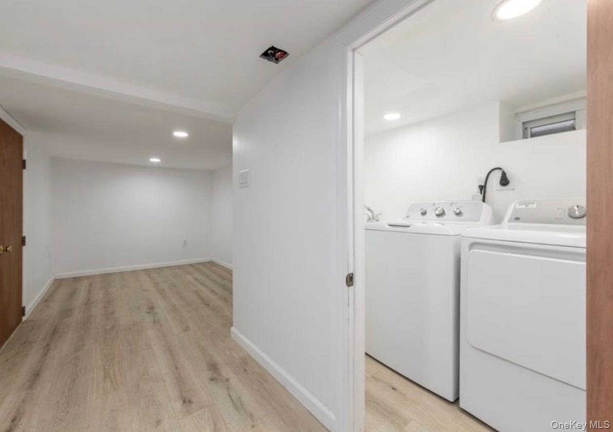 136-18 221st Street Queens, NY 11413 - Photo 18 of 23 Washroom with recessed lighting, light wood-style flooring, and washer and clothes dryer