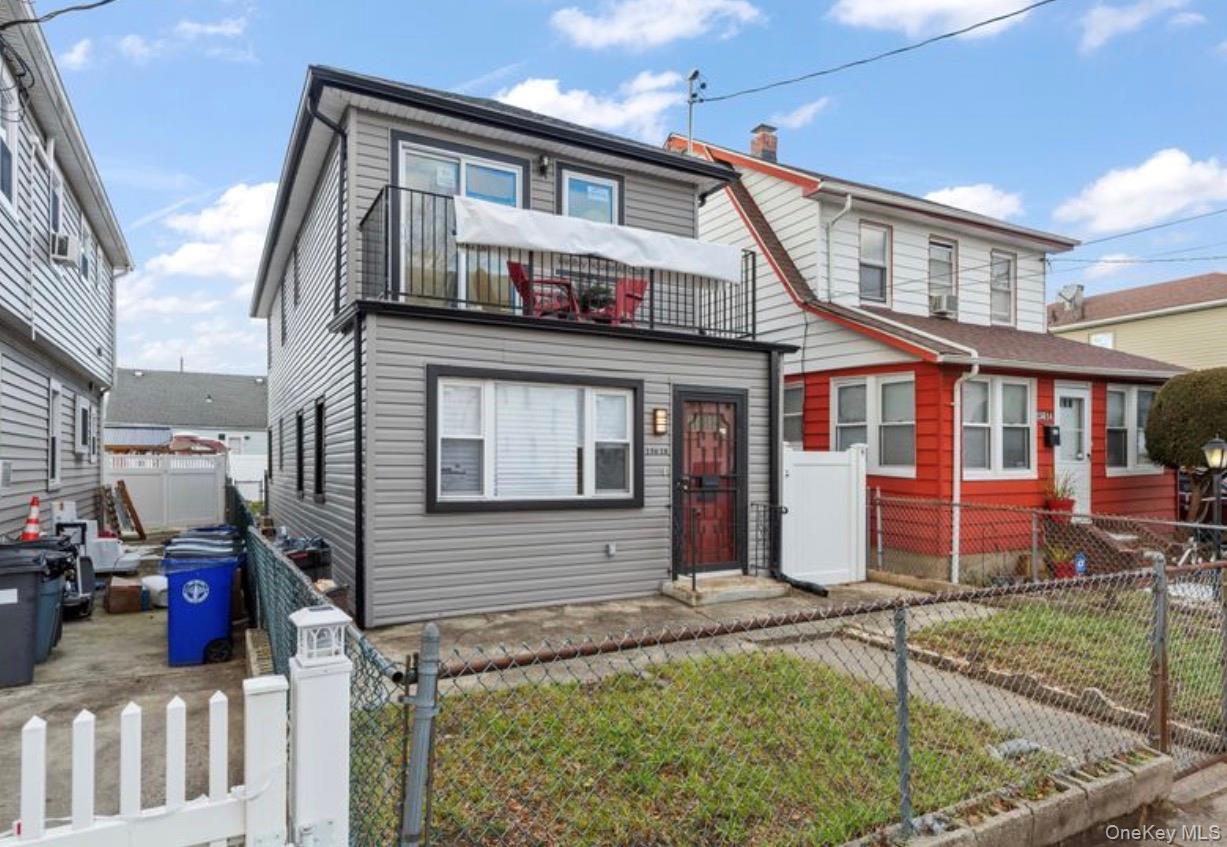 136-18 221st Street Queens, NY 11413 - Photo 2 of 23 View of front of house featuring a fenced front yard and a gate