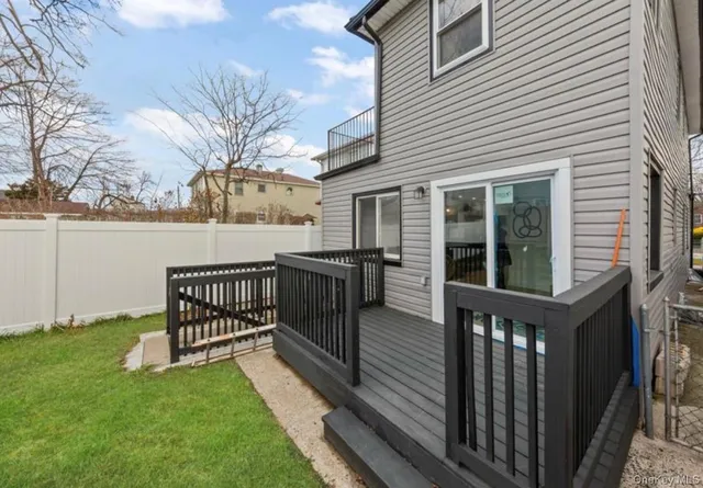 a view of a house with a wooden deck