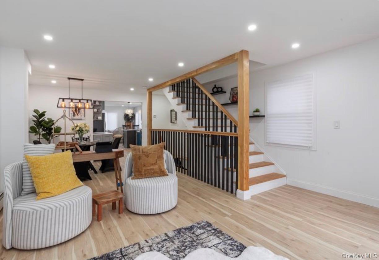 136-18 221st Street Queens, NY 11413 - Photo 4 of 23 Living room featuring stairs, recessed lighting, and light wood-style flooring