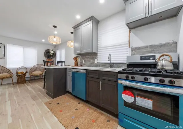 a kitchen with a stove a sink and a microwave