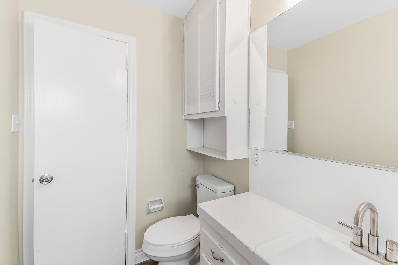 44446 Loneoak Avenue Lancaster, CA 93534 - Photo 17 of 20 a white toilet sitting next to a bathroom sink