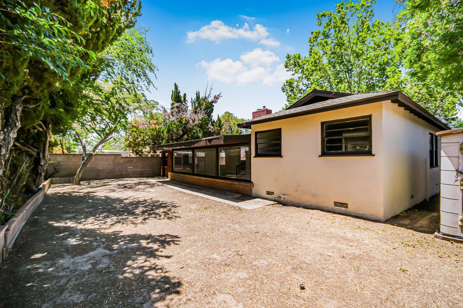 44446 Loneoak Avenue Lancaster, CA 93534 - Photo 20 of 20 a backyard of a house with large trees and outdoor space