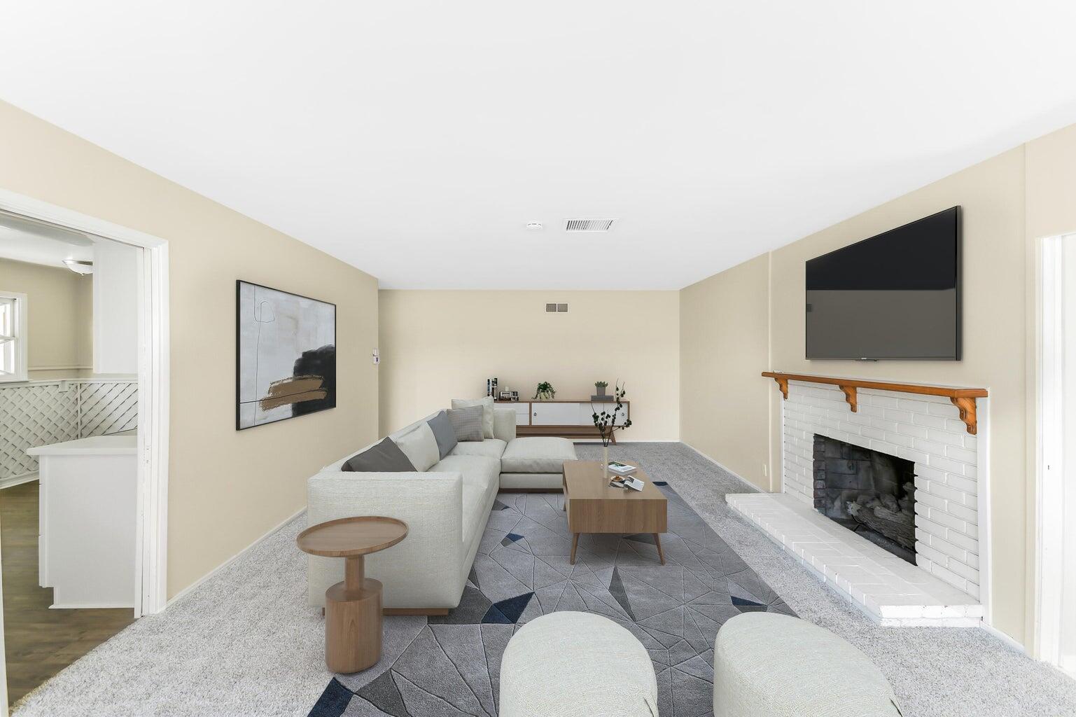 44446 Loneoak Avenue Lancaster, CA 93534 - Photo 2 of 20 a living room with furniture a flat screen tv and a fireplace