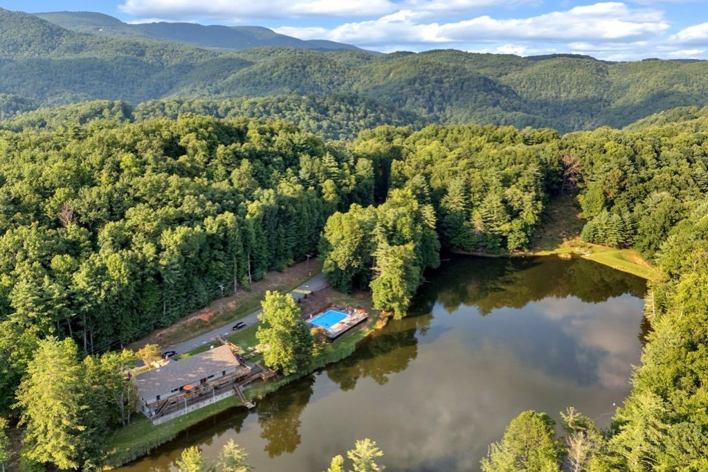 216 Saddle Lane Deep Gap, NC 28618 - Photo 36 of 44 a view of a lake with mountains in the background