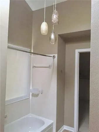 a bathroom with a shower and a mirror