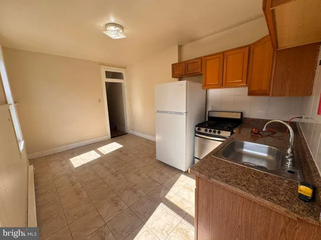 a kitchen with a sink a stove and refrigerator