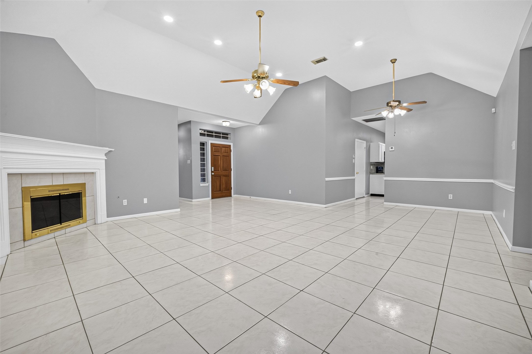 13607 Sable Lane Houston, TX 77014 - Photo 11 of 46 a view of a livingroom with a ceiling fan a chandelier and fireplace