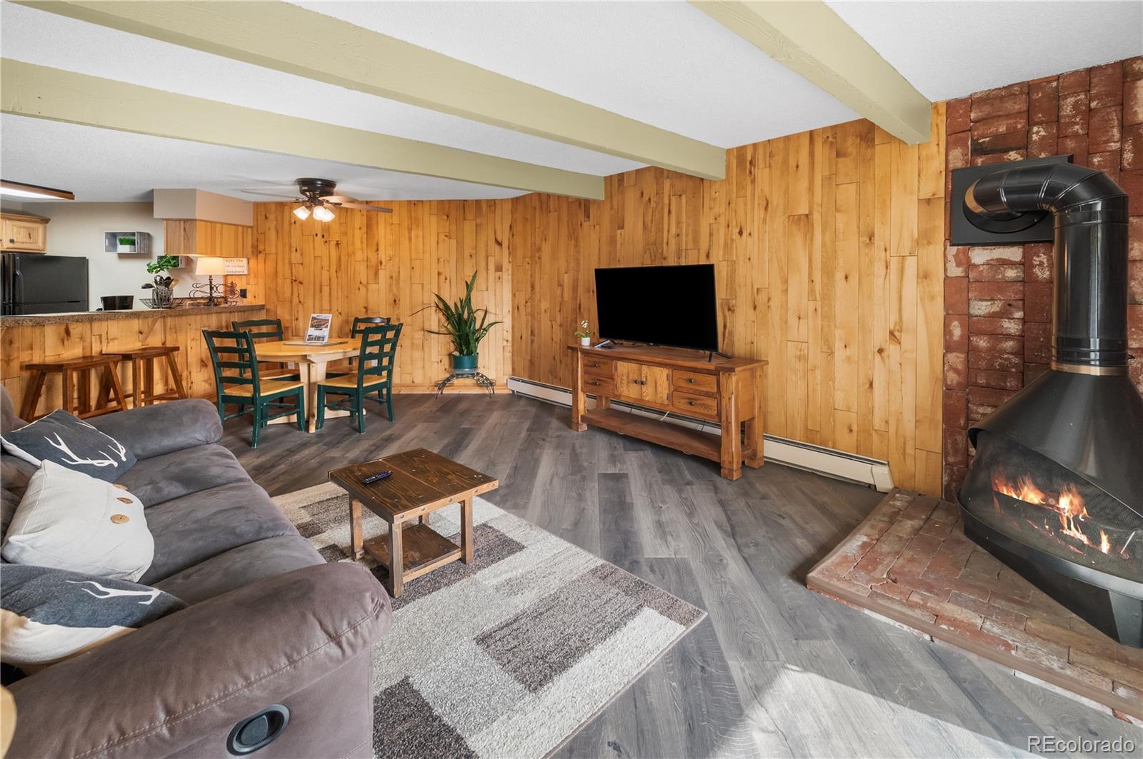 7222 Ryan Gulch Road, Unit 202 Silverthorne, CO 80498 - Photo 11 of 36 a living room with furniture and a flat screen tv