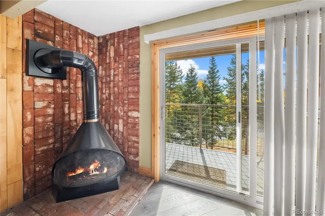 a room with wooden floor and a fireplace