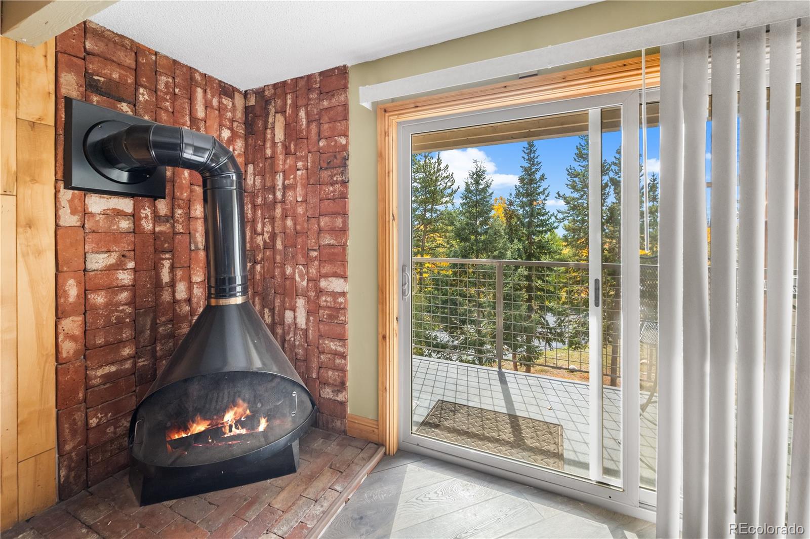 7222 Ryan Gulch Road, Unit 202 Silverthorne, CO 80498 - Photo 12 of 36 a room with wooden floor and a fireplace