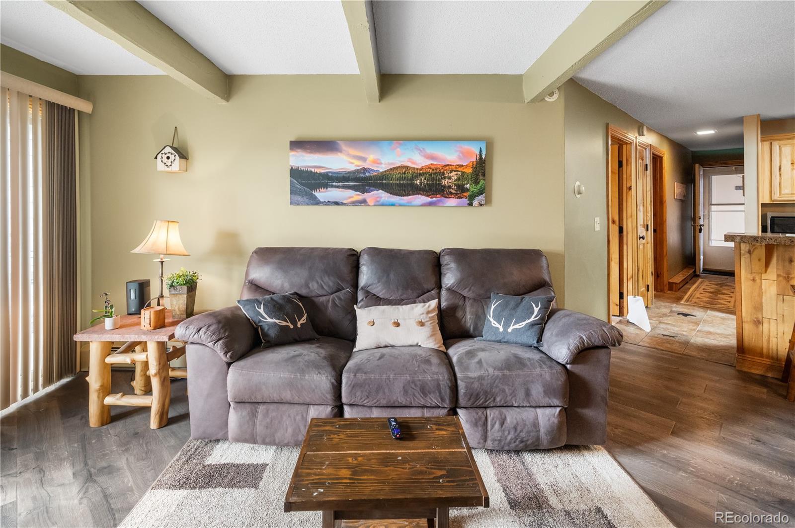 7222 Ryan Gulch Road, Unit 202 Silverthorne, CO 80498 - Photo 13 of 36 a living room with furniture and wooden floor