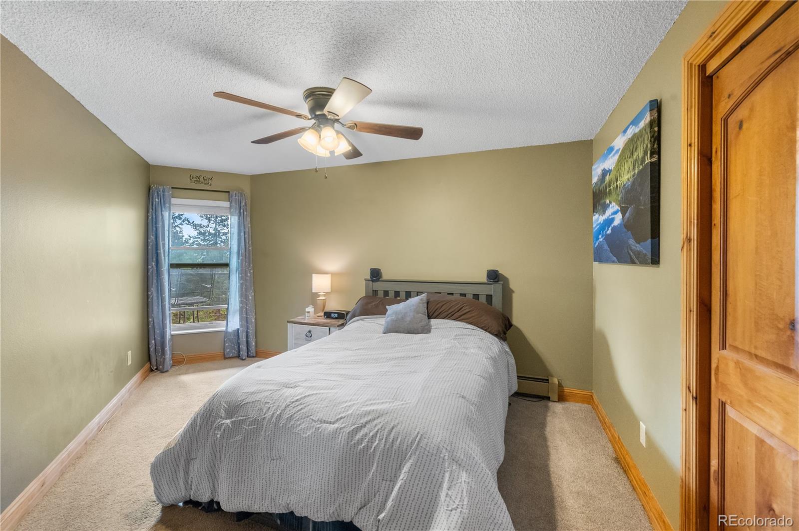 7222 Ryan Gulch Road, Unit 202 Silverthorne, CO 80498 - Photo 16 of 36 a bedroom with a bed and a mirror