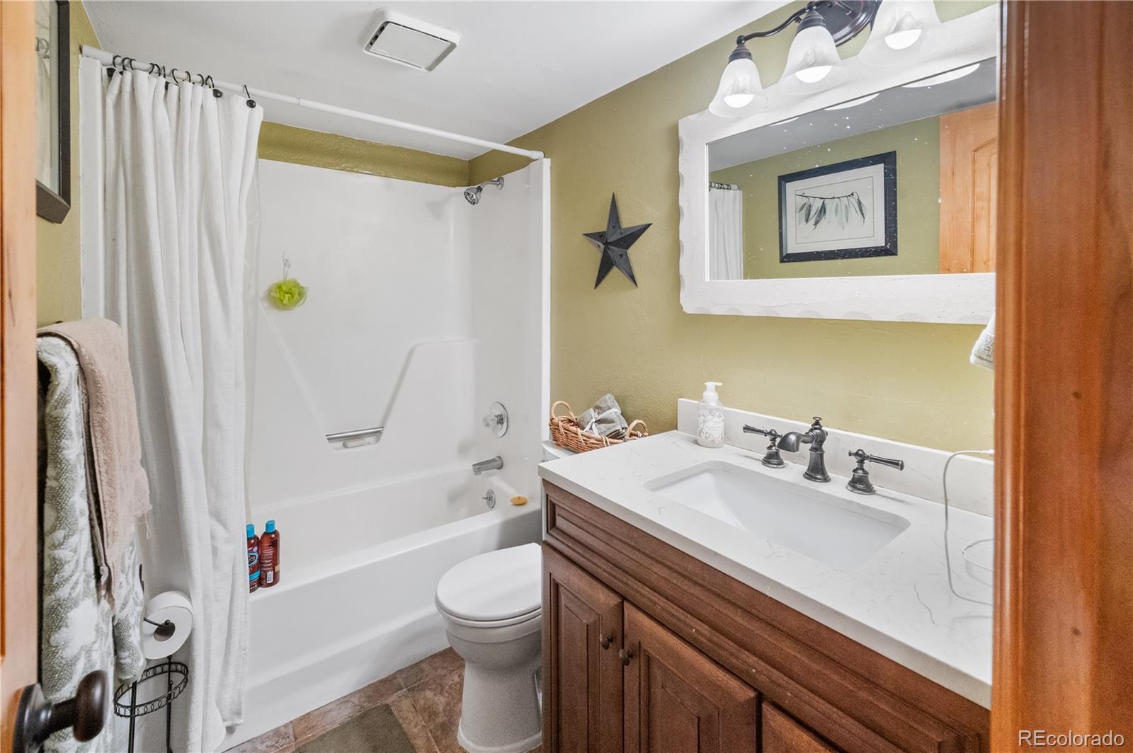7222 Ryan Gulch Road, Unit 202 Silverthorne, CO 80498 - Photo 18 of 36 a bathroom with a sink toilet and shower