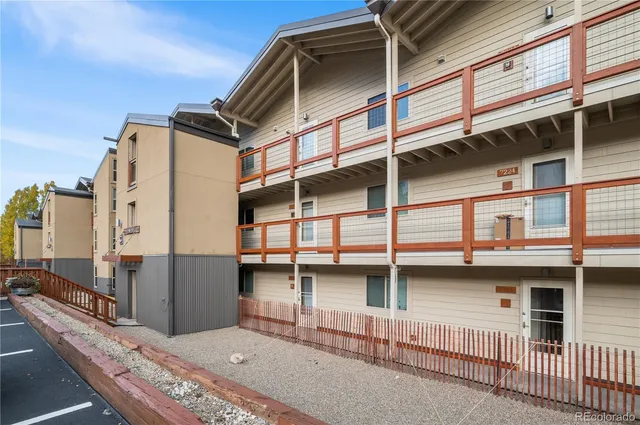 a view of balcony with two large windows and wooden fence