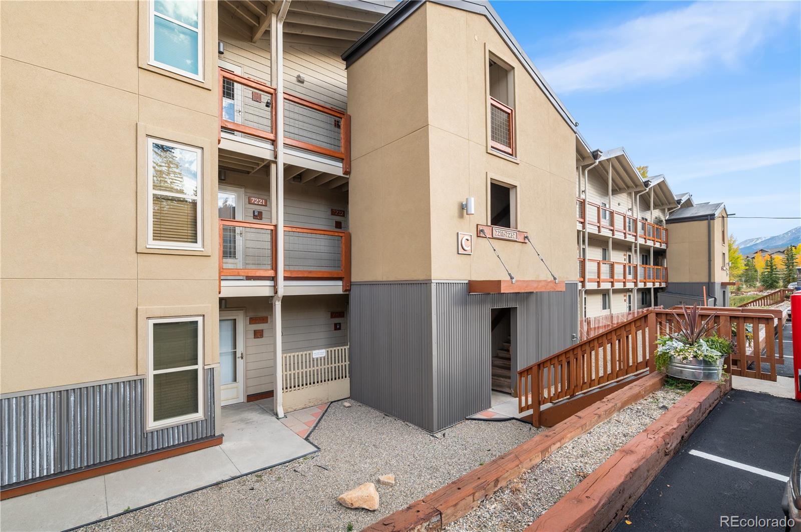 7222 Ryan Gulch Road, Unit 202 Silverthorne, CO 80498 - Photo 25 of 36 a view of balcony with two large windows and wooden fence