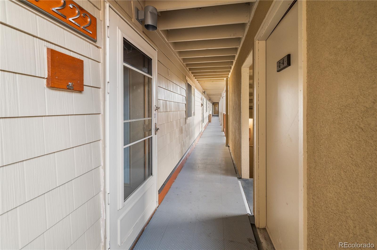 7222 Ryan Gulch Road, Unit 202 Silverthorne, CO 80498 - Photo 4 of 36 a view of a hallway with wooden floor and staircase