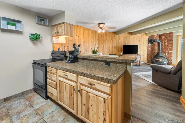 a view of a kitchen counter top space with flat screen tv