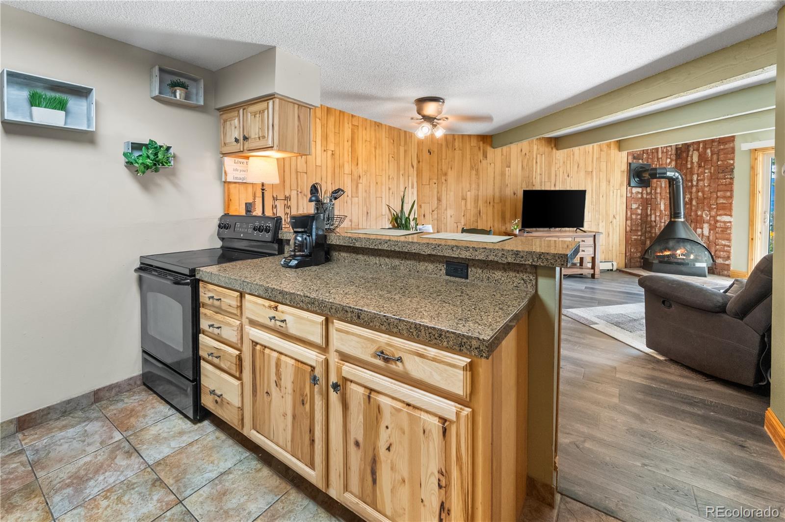 7222 Ryan Gulch Road, Unit 202 Silverthorne, CO 80498 - Photo 6 of 36 a view of a kitchen counter top space with flat screen tv
