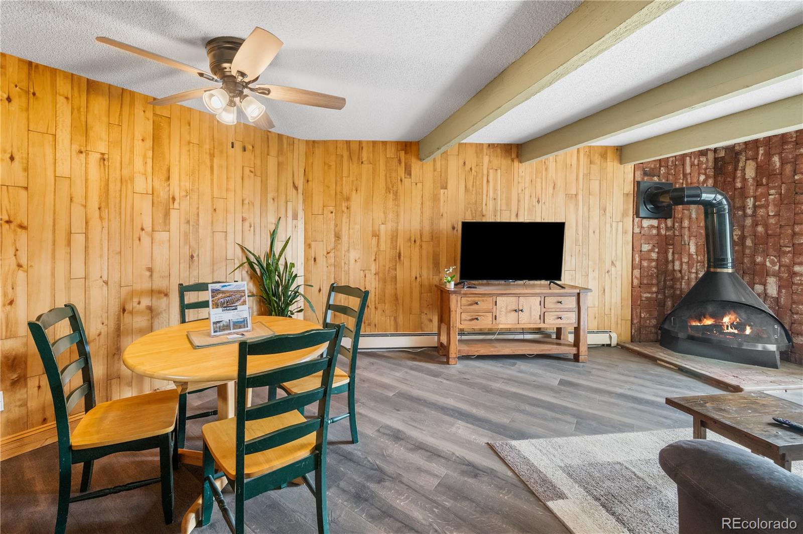 7222 Ryan Gulch Road, Unit 202 Silverthorne, CO 80498 - Photo 10 of 36 a living room with furniture and a flat screen tv