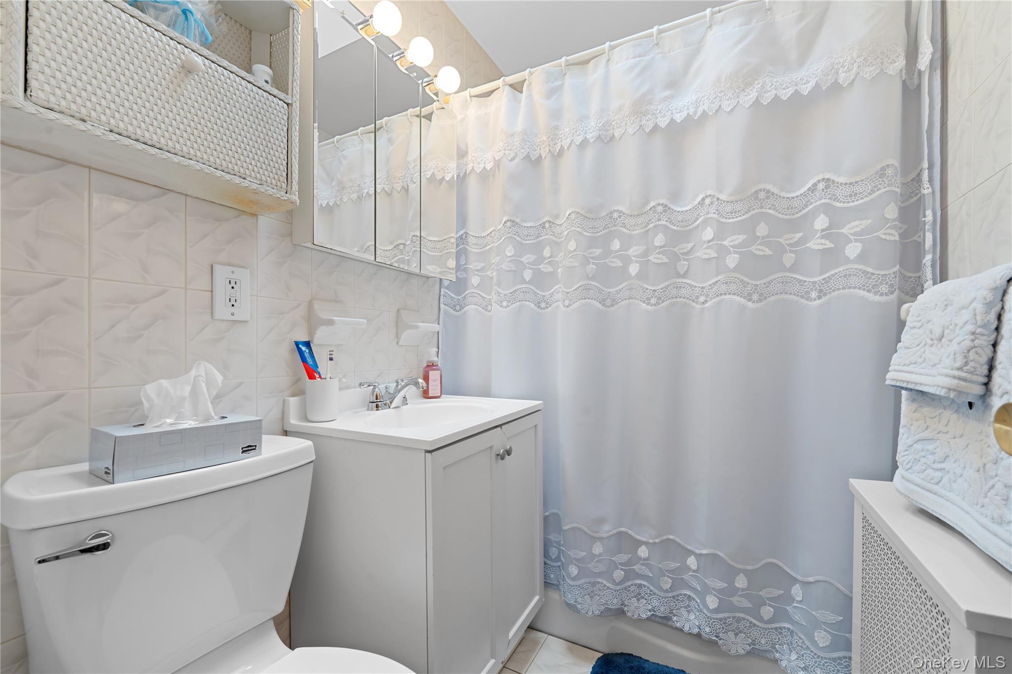 301 Bay 19th Street, Unit B Brooklyn, NY 11214 - Photo 11 of 13 a bathroom with a sink toilet and shower