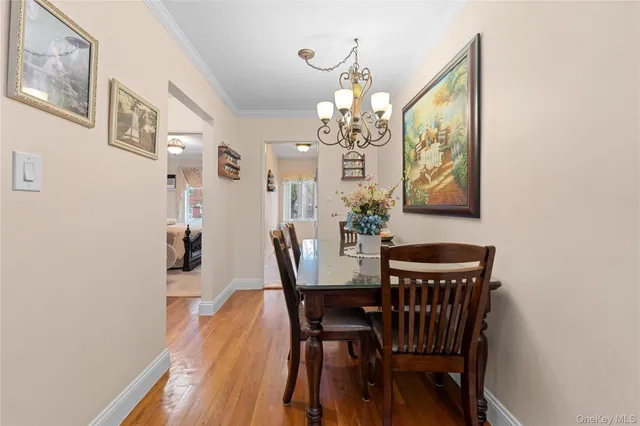 a view of a dining room with furniture and chandelier