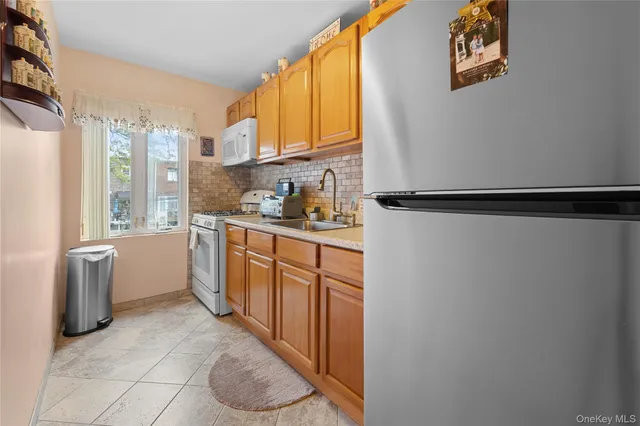 a kitchen with stainless steel appliances a refrigerator sink and cabinets