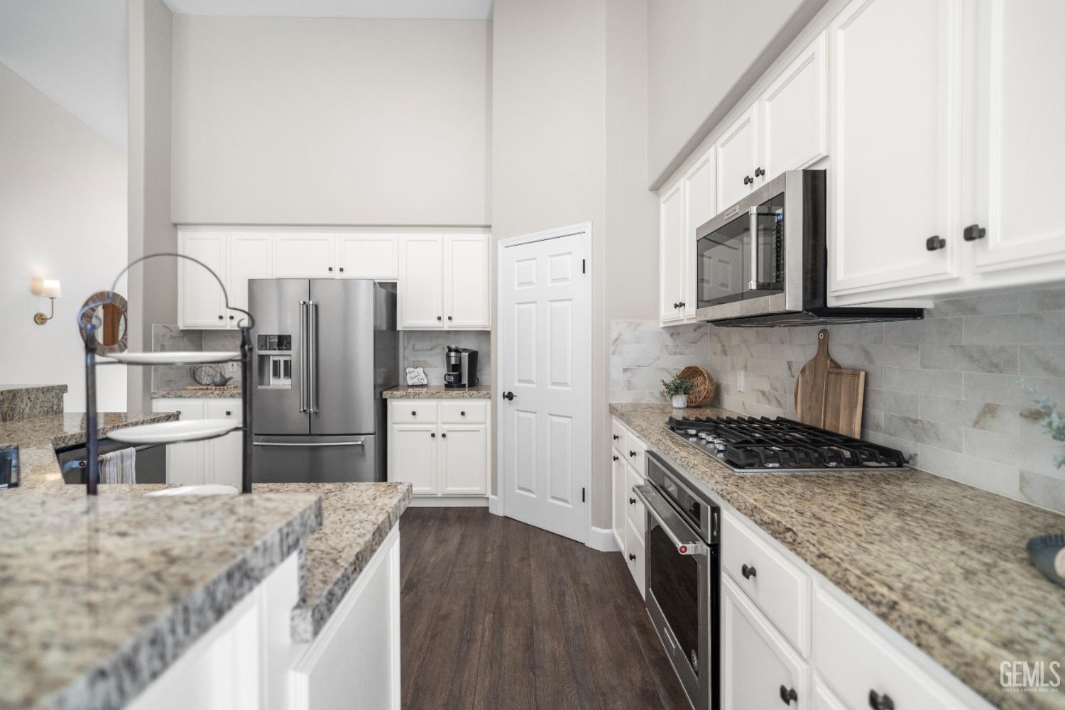 Undisclosed Address Bakersfield, CA 93308 - Photo 13 of 37 a kitchen with stainless steel appliances granite countertop a sink stove and refrigerator