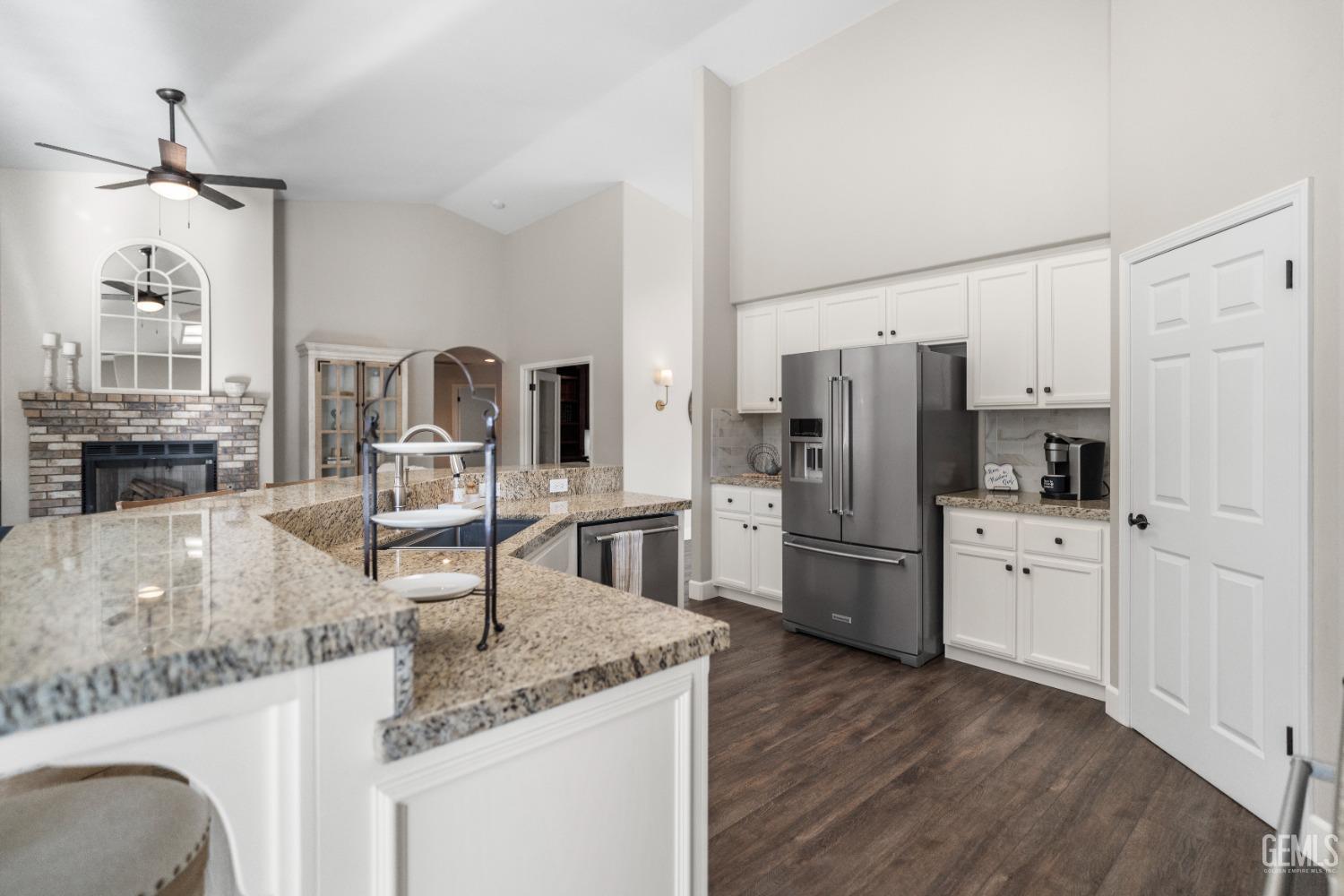 Undisclosed Address Bakersfield, CA 93308 - Photo 15 of 37 a kitchen with refrigerator cabinets and wooden floor