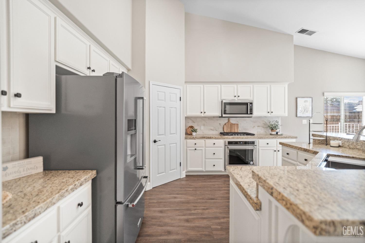 Undisclosed Address Bakersfield, CA 93308 - Photo 17 of 37 a kitchen with a sink stove and refrigerator