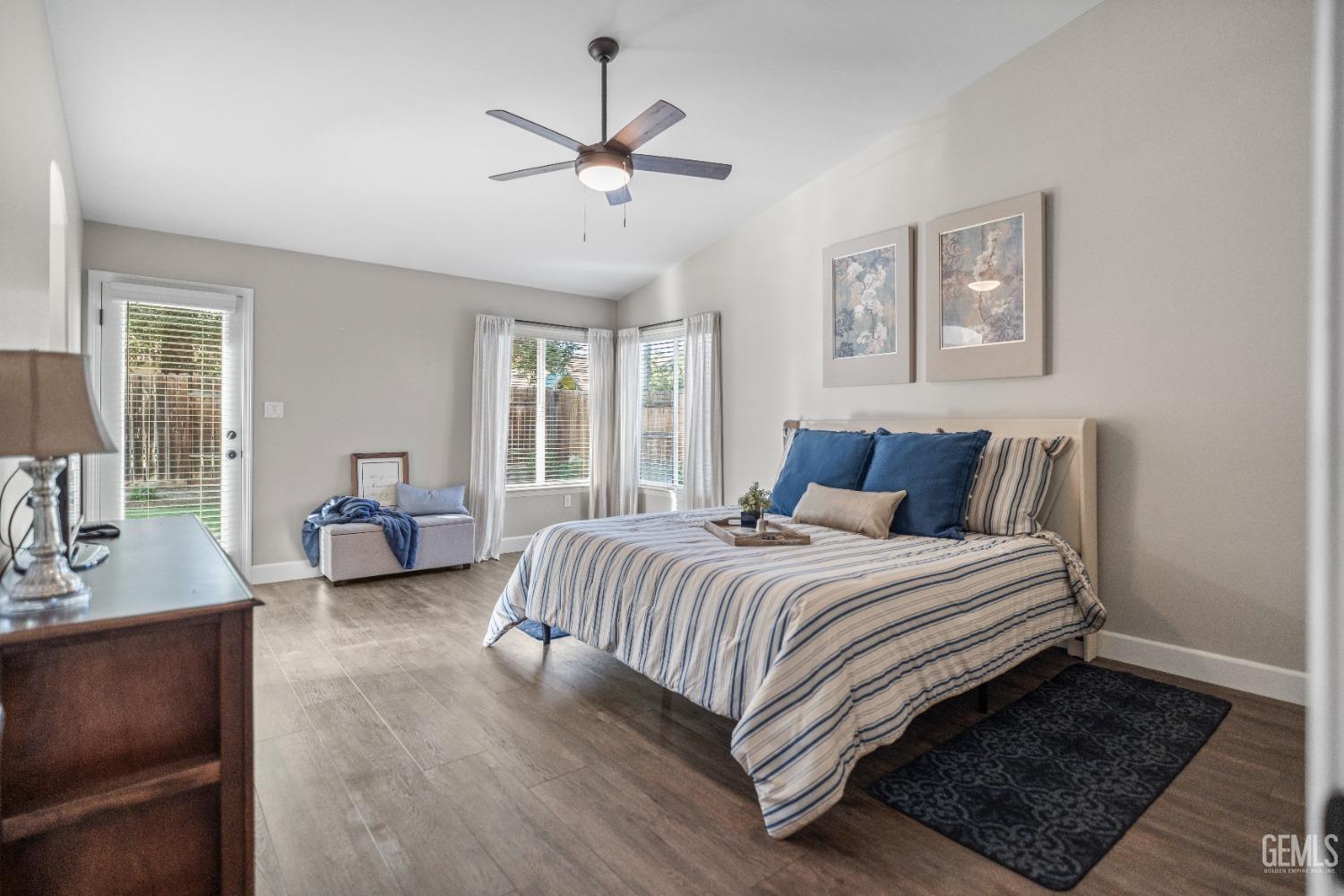 Undisclosed Address Bakersfield, CA 93308 - Photo 24 of 37 a spacious bedroom with a bed a chandelier and a window