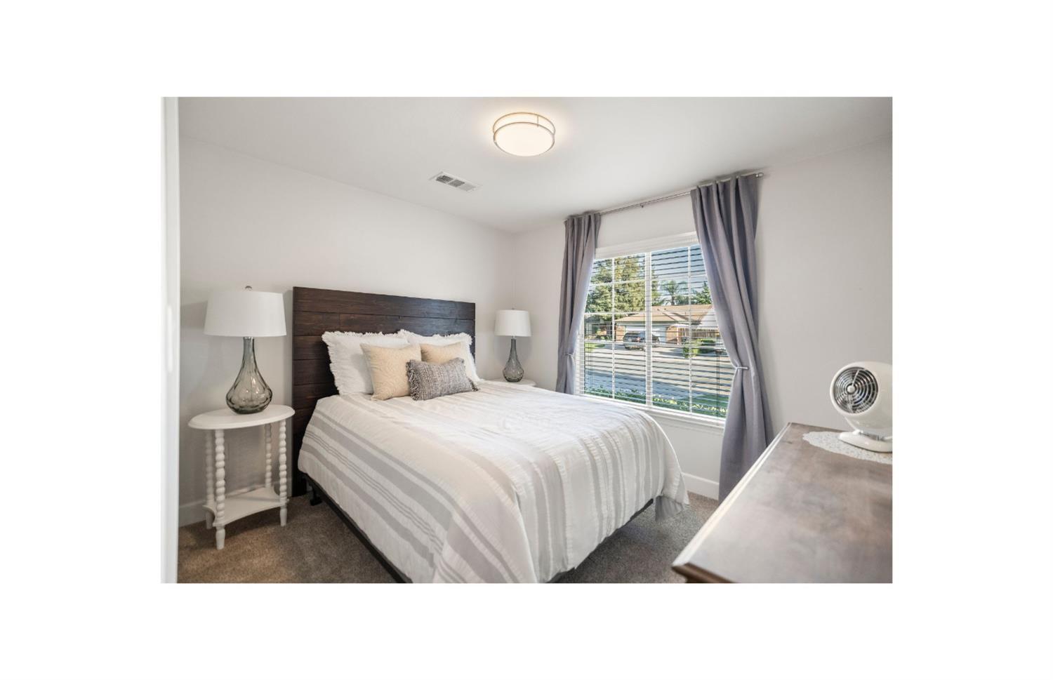 Undisclosed Address Bakersfield, CA 93308 - Photo 32 of 37 a bed room with a bed and a large window