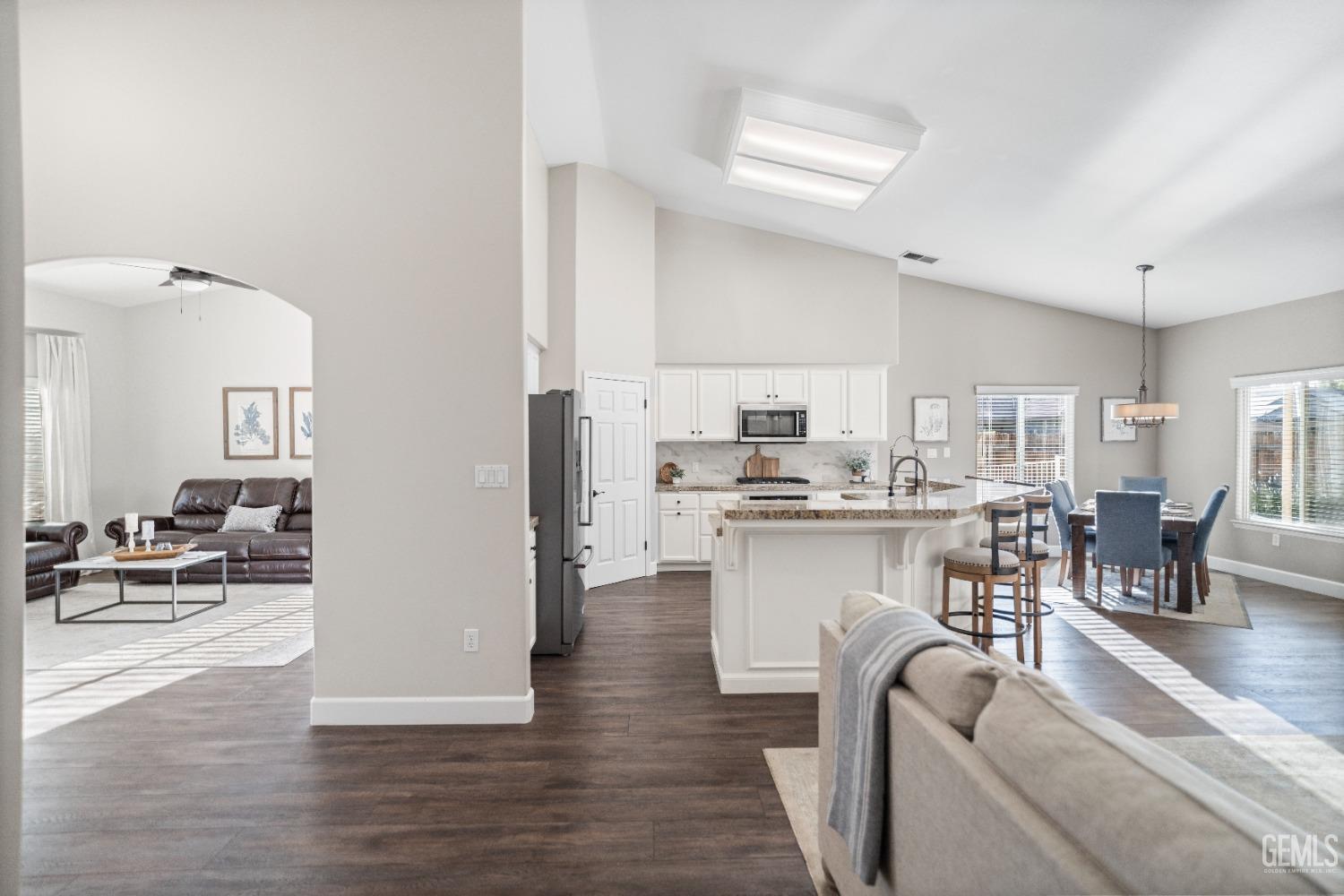 Undisclosed Address Bakersfield, CA 93308 - Photo 6 of 37 a living room with stainless steel appliances kitchen island granite countertop furniture and a wooden floor