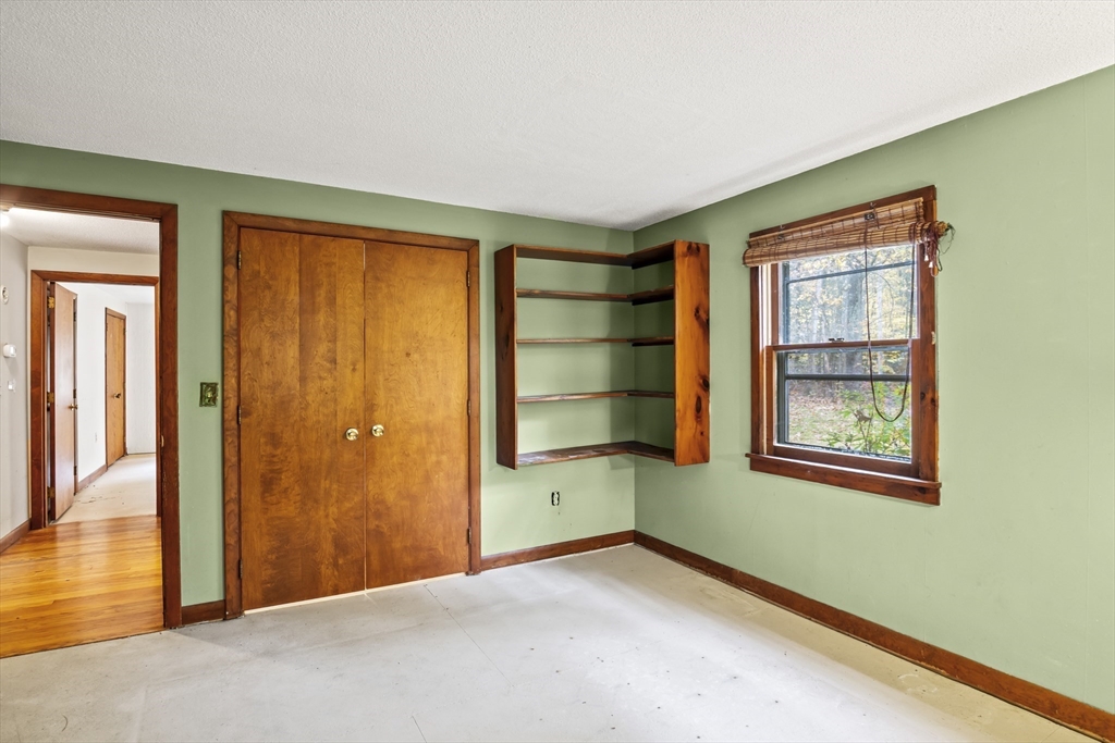 55 Putney Road Leverett, MA 01054 - Photo 20 of 40 a view of an empty room with a window and wooden floor