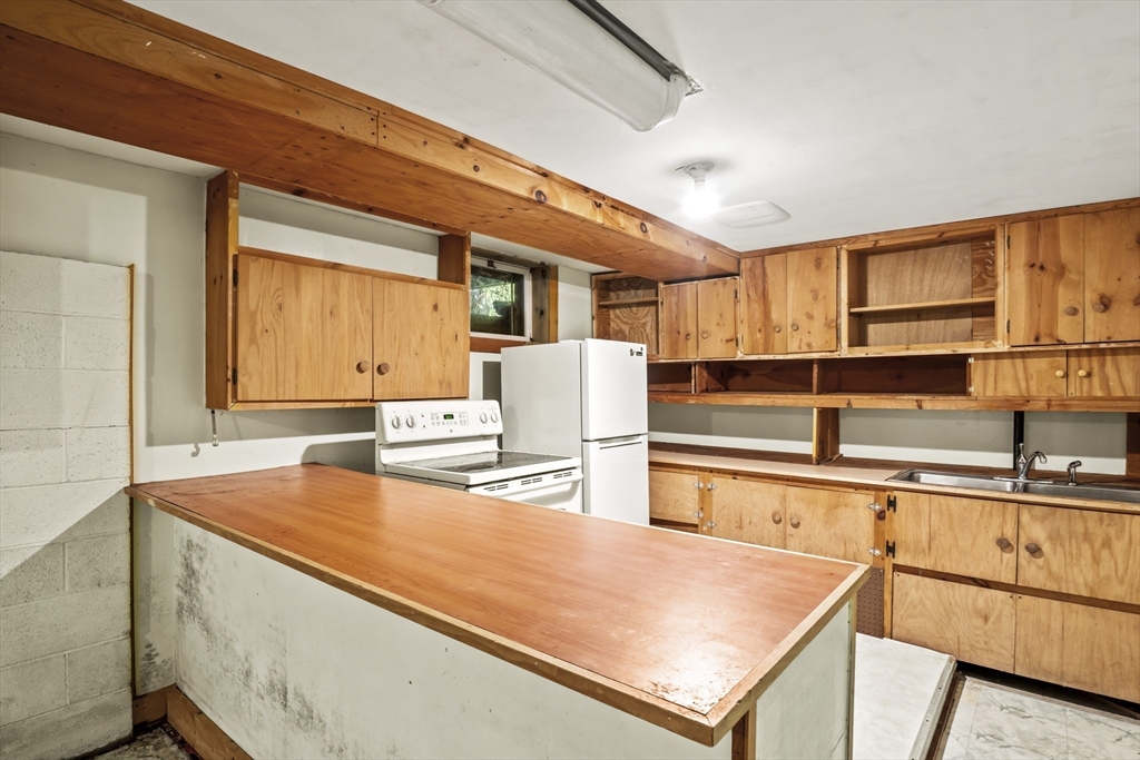 55 Putney Road Leverett, MA 01054 - Photo 25 of 40 a kitchen with stainless steel appliances granite countertop a sink and a refrigerator